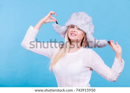 Accessories and clothes for cold days, fashion concept. Blonde woman in winter warm furry hat in russian style.