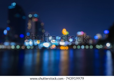 Night twilight blurred bokeh city downtown water front, abstract background
