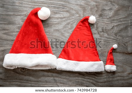 Christmas santa claus hats over wooden background. Xmas concept over grunge wooden background