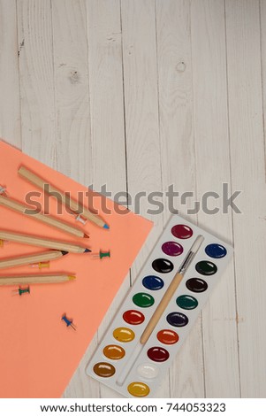 paint for drawing, pencils, colored paper on a light background top view,  free place                              