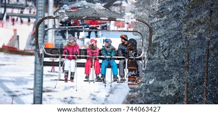 People are lifting on ski-lift for skiing in the mountains