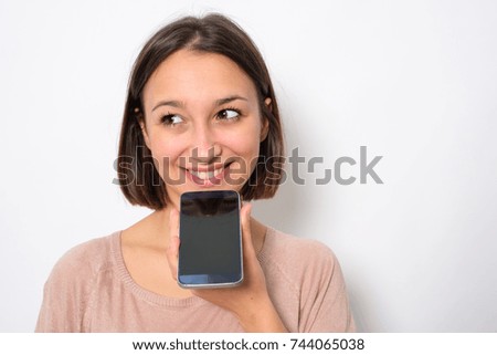 Young woman using phone vocal assistant and sending vocal message