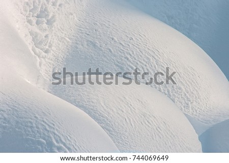 Natural snow texture. Clean fresh snow. Snow cover on the ground. Winter background with snow patterns  for Christmas and New Year design. Closeup top view.
