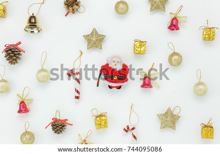 Flat lay of decoration & ornament Merry Christmas concept.Santa Claus and accessory for season on the white background.Variety objects arrangement on modern white table at home office desk studio.  