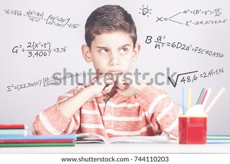Young school boy having trouble with his homework