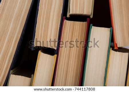 Back to school and education concept - top view of colorful hardback books. Close up