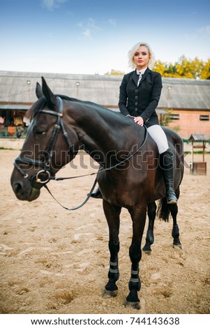 Equestrian sport, woman poses on horseback