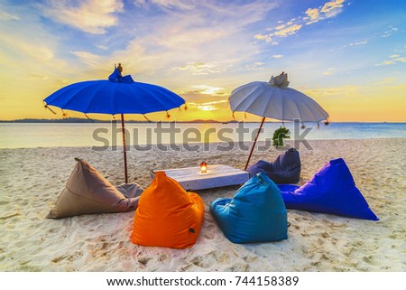 Lounge Chair in sunset in white sand which is a very attractive tourist destination in bintan Royalty-Free Stock Photo #744158389
