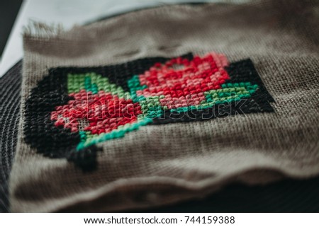 Roses embroidered on a cross stitch