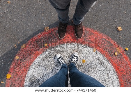 young woman and man facing each other at the streets in a circle, personal pespective - pov Royalty-Free Stock Photo #744171460