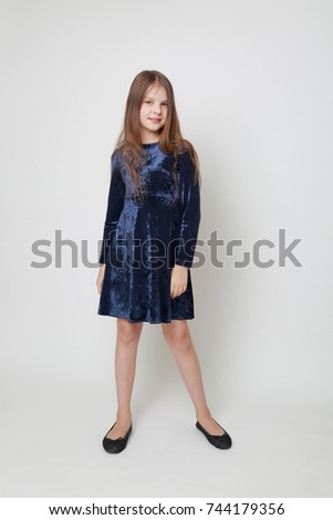 Gorgeous teen girl in a dress posing for a studio portrait