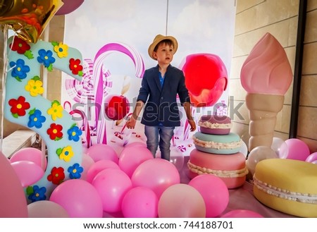 Cute Caucasian boy at a girl's birthday party, feeling confused, gender issues stock image.