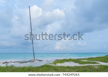 White Sailboat on Tropical Beach Shore