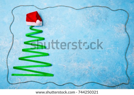 Christmas background. Christmas tree made from ribbon on blue. Copy space. Top view