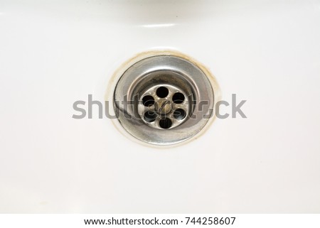 clean white water drain hole in a bath horizontal view