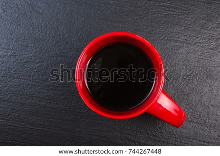 cup of coffee on black wooden background