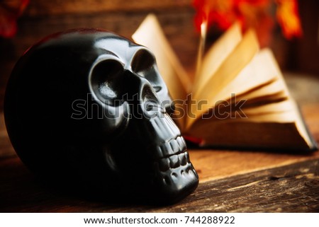 mystic background: black book, skull and candle