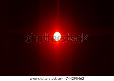 The bright red illumination on the black background. anamorphic lens flare