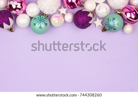 Modern pastel Christmas bauble top border over a light purple background