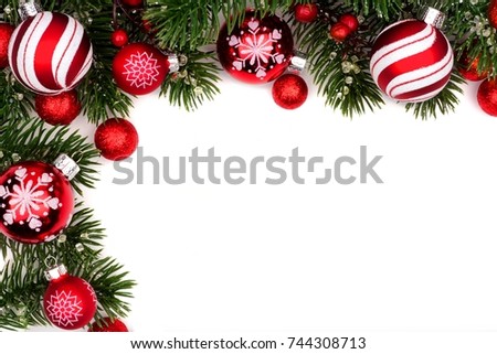 Christmas corner border of red and white baubles with branches isolated on a white background