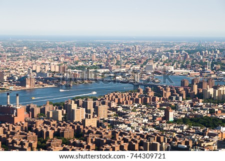 Panoramic photo of Manhattan skyline, skyscrappers, buildings, river in sunny day.