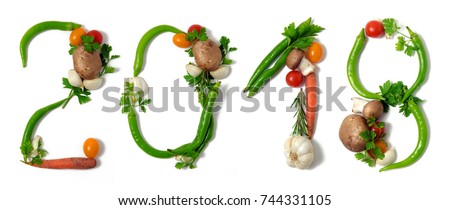 Number 2018 written with vegetables, as a metaphor or concept for healthy food, living, diet, recipe. Isolated on white background. Happy new year. End of the year resolution Royalty-Free Stock Photo #744331105