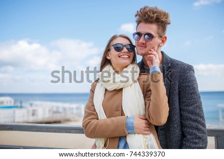 Cheerful young couple having fun and laughing together outdoors.