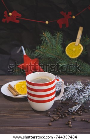 Cup of coffee and christmas snow fir branch on wooden table
