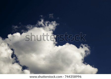 part of a blue saturated sky with white clouds on it, close-up