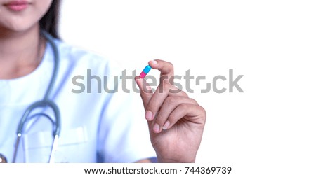 young doctor holding single medicine, pill, capsule isolated on white background with clipping path 

