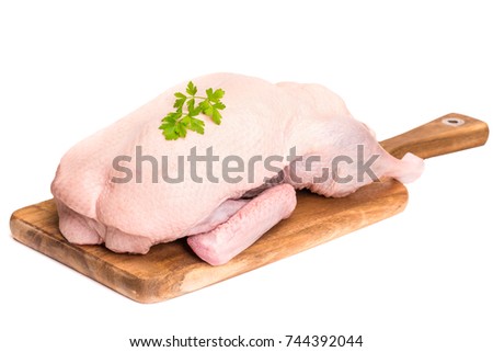 Raw duck on a wooden board on a white background