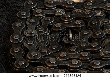 Metal Chain round up circle on black fabric, close up macro stacking photography, dark exposure