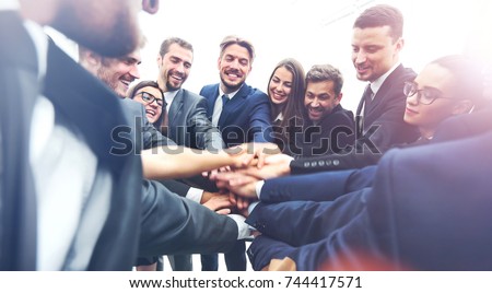 Large business team showing unity with their hands together Royalty-Free Stock Photo #744417571