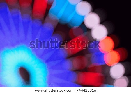 Blur texture of colorful carnival Ferris wheel lights