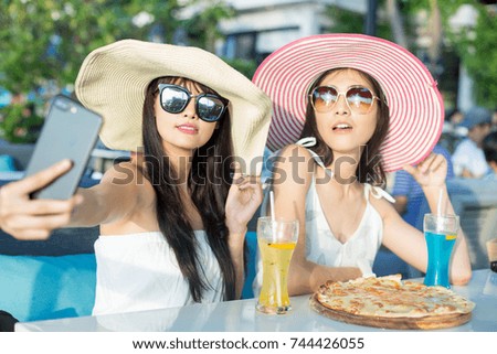 Beautiful Asian Woman have dinner at reataurant with friend, Woman using Smartphone for Selfie, People Lifestyle Concept.