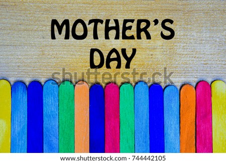 MOTHER'S  DAY words with Colorful Wood Ice Cream sticks over white background