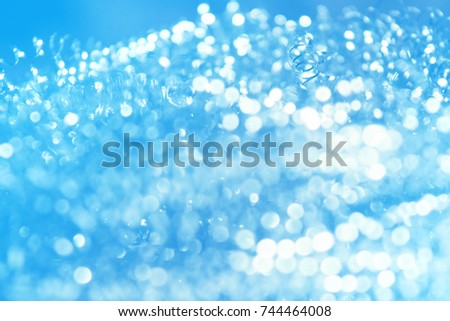 abstract white Bokeh circles Christmas on blue background, glitter light Defocused
