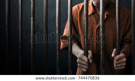 Man in prison Royalty-Free Stock Photo #744470836
