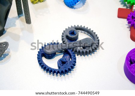 Abstract models printed by 3d printer close-up. Bright colorful objects printed on a 3d printer on a white table. Progressive modern additive technology. Concept of 4.0 industrial revolution
