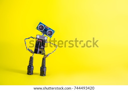 Funny cheerful cute charming robot on a yellow background. Repair, humanoid, technology, future, communication, internet, technology, cars concept.