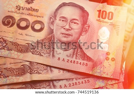close up of thai banknote,thai bath with the image of Thai King Bhumibol Adulyadej,100 thai baht.Thai currency concepts.
