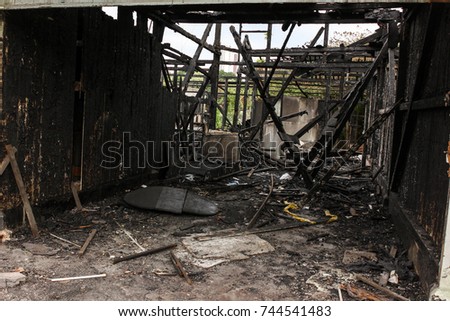 Old wooden house after the fire burned