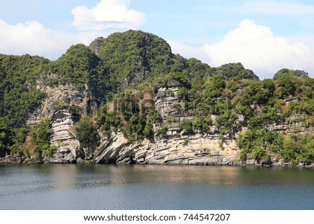 Beautiful Ha Long bay in Vietnam with water, mountains and green vegetation