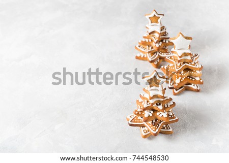 Christmas background with gingerbread fir over grey texture