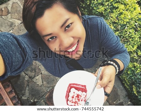 Woman taking a selfie with cake red velvet
