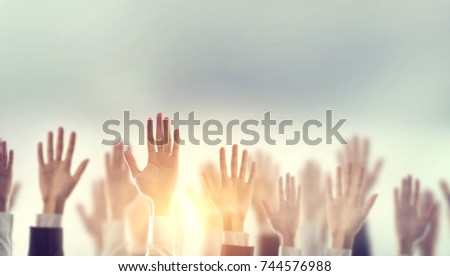 Businessman Hands raising for Participation with sunlight, Silhouette, copy space. Royalty-Free Stock Photo #744576988