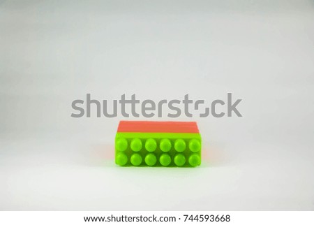 Red and green plastic building blocks isolated on white background
