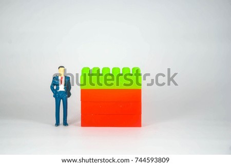 Plastic building blocks bussinesman miniature isolated on white background
