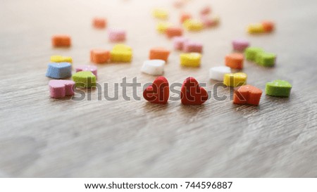 Two red hearts. Decorative colourful sponge is small heart blurred background. Valentine day concept.