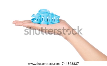 hand holding plastic hair clip isolated on white background Royalty-Free Stock Photo #744598837